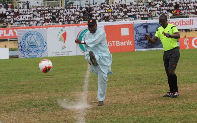 Ogun State Governor, Sen. Ibikunle Amosun flags off the final match with a ceremoinal kick
